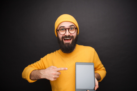 Cheerful man pointing at tabletの写真素材