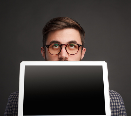 Pensive man showing laptopの写真素材