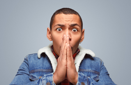 Stressed man praying for the bestの写真素材