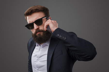 Stylish brutal man speaking on phoneの写真素材