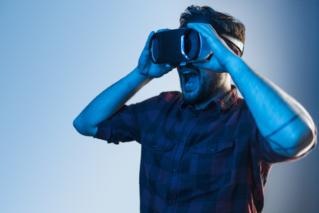 Shocked man in VR glasses