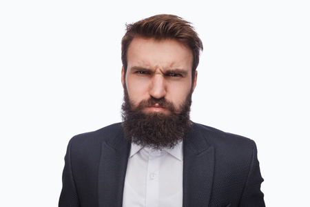 Grumpy bearded man in suit on whiteの写真素材