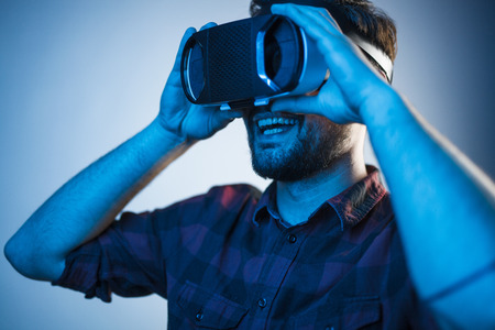 Excited man testing VR glassesの写真素材