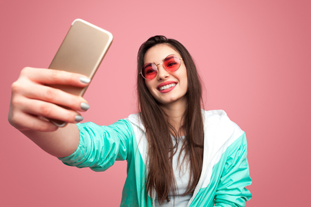 Stylish hipster woman taking selfieの写真素材