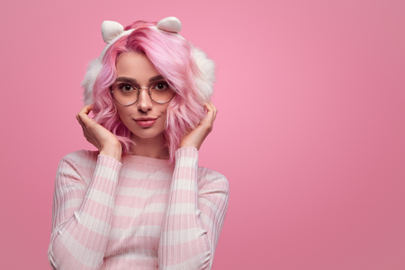 Charming hipster woman wearing earmuffsの写真素材