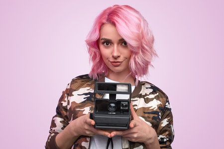 Trendy hipster woman with retro photo cameraの写真素材