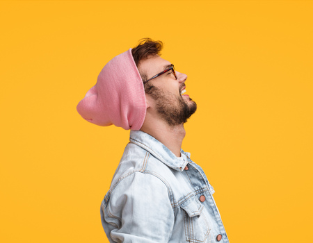 Guy in glasses and hat laughingの写真素材