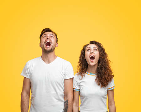 Shocked couple looking upの写真素材