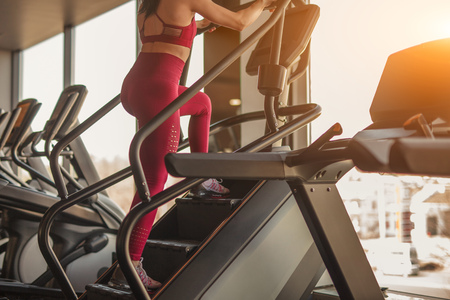 Woman training on stepper in gym