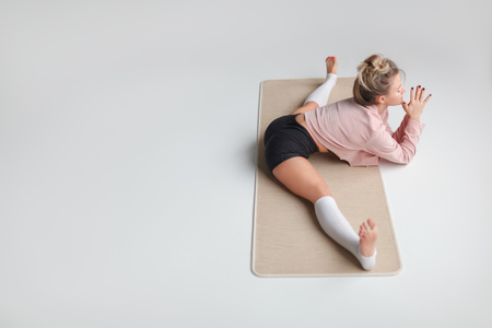 Young female doing Side Splitsの写真素材