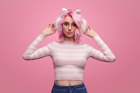 Adorable young woman in earmuffsの写真素材