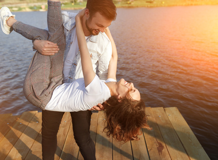 Happy couple having fun on pierの写真素材