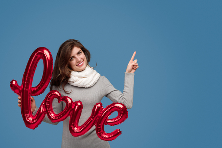 Woman with love writing pointing upの写真素材