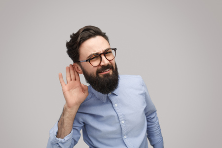 Bearded man listening closelyの写真素材