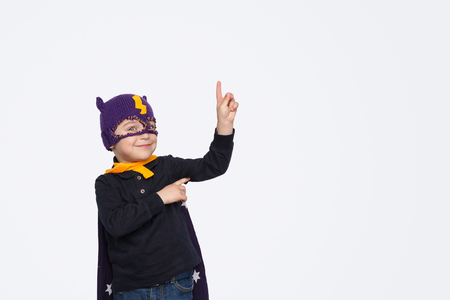 Little superhero smiling and pointing upの写真素材
