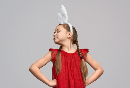 Cute proud girl in white bunny earsの写真素材