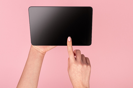 Woman tapping on screen of tabletの写真素材