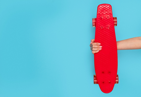 Stylish red longboard on blue backgroundの写真素材