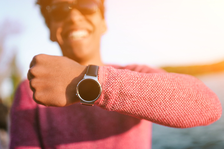 Trendy black man showing modern wristwatchの写真素材