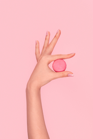 Crop hand demonstrating macaronの写真素材