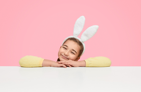 Dreamy little girl in white fluffy earsの写真素材