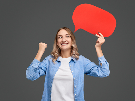 Woman with speech balloon celebrating success