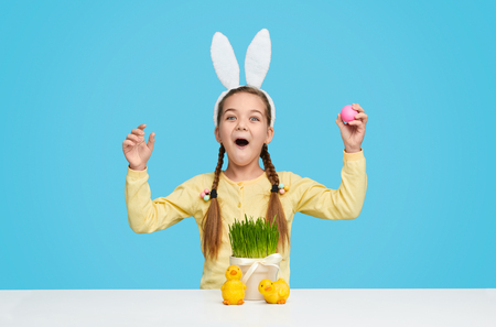 Amazed girl in bunny ears celebrating Easterの写真素材