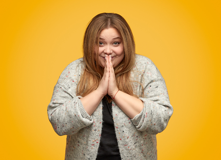 Cheerful plump female making wish