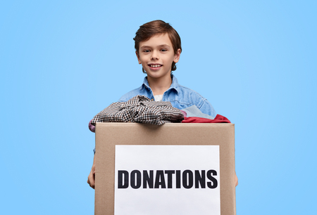 Kid holding box with donationsの写真素材