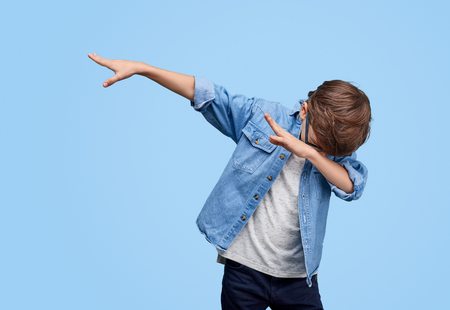 Stylish kid performing dab dancingの写真素材