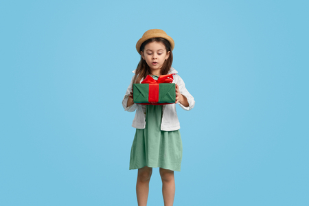 Surprised girl with presentの写真素材