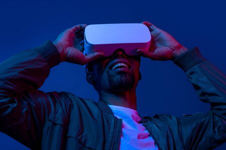 Smiling black male using VR glasses