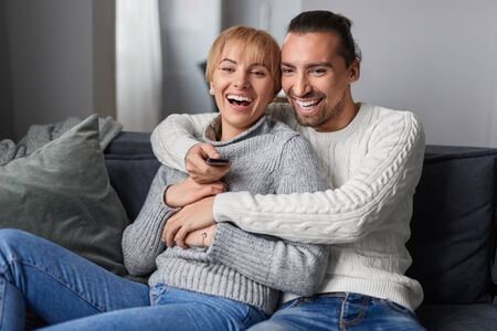 Happy couple watching TVの写真素材