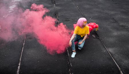 Trendy teen hipster sitting near smoke bombの写真素材