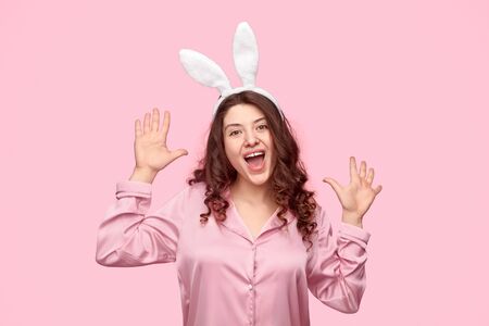 Cheerful woman in pajama and bunny earsの写真素材