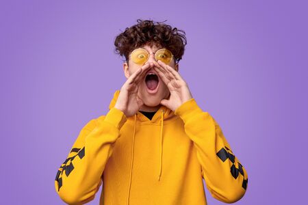 Teen boy making loud announcement