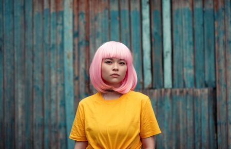 Teen girl against grungy wallの写真素材