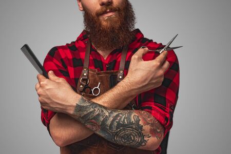 Crop bearded barber with toolsの写真素材