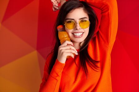 Cheerful young woman with juice