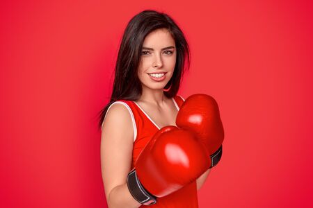 Smiling female boxer in gloves