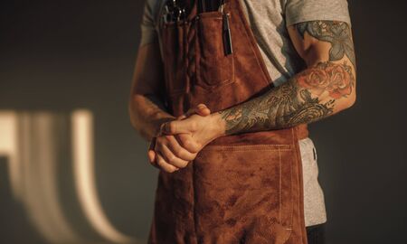 Crop barber clasping handsの写真素材