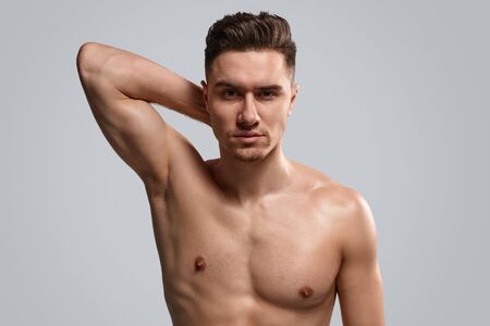 Handsome shirtless man showing muscleの写真素材