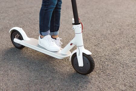 Crop person on modern electric scooterの写真素材