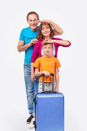 Family of travelers looking at cameraの写真素材