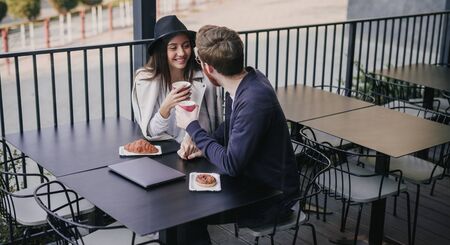 Stylish multiracial couple on date in cafe