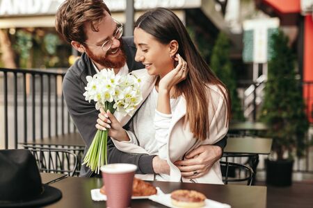 Man hugging woman at first dateの写真素材