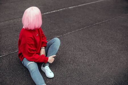 Anonymous hipster looking back on streetの写真素材