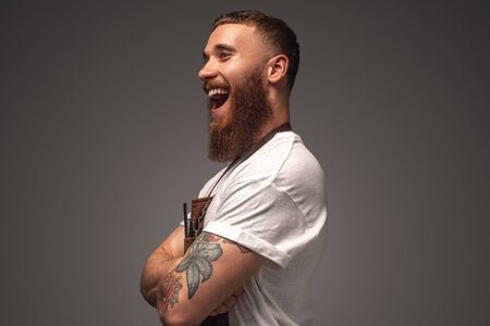 Positive stylist laughing with crossed armsの写真素材