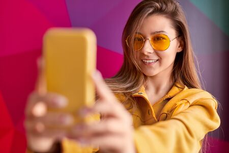 Smiling woman taking selfieの写真素材