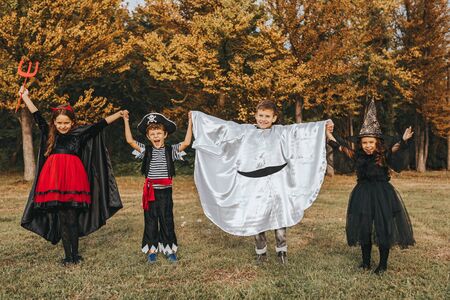 Cute children in Halloween costumes on nature backgroundの写真素材